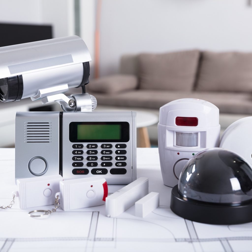 Close-up,Of,Home,Security,Equipment,On,Blueprint