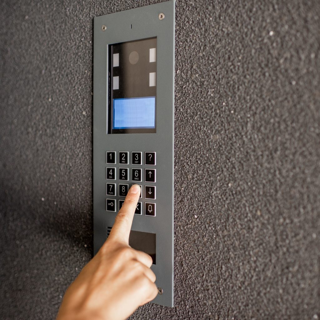 Close-up,Of,Intercome,Keyboard,Of,Residential,Building,With,Finger,Entering