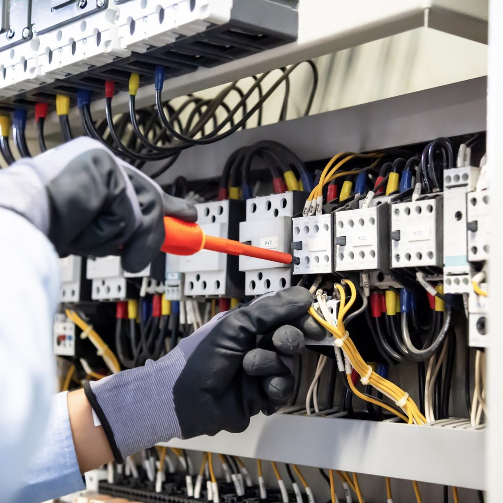 Electricians,Work,To,Connect,Electric,Wires,In,The,System,,Switchboard,